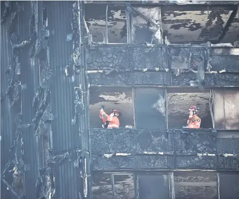  ??  ?? Members of the emergency services work inside the charred remains of the Grenfell apartment tower block in North Kensington, London. — Reuters photo
