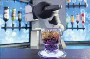  ?? REUTERS ?? A robot bartender serves a soft drink at the ‘Barney Cocktail Bar’ in Zurich.