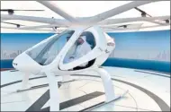  ?? AFP ?? Dubai Crown Prince Sheikh Hamdan bin Mohammed sits in the prototype flying taxi that was tested unmanned on Monday.