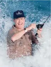  ?? —AFP ?? FLORIDA: In this file photo taken on November 14, 1988 President elect George HW Bush is smashed by a wave while fishing in back of the home of William Farish in Florida.