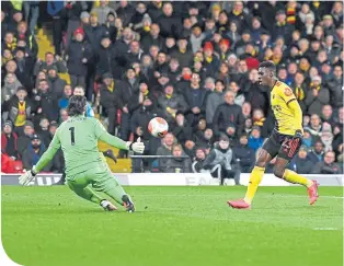  ??  ?? Ismaila Sarr clips the ball over Liverpool keeper Alisson Becker to make it 2-0