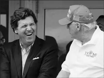  ?? SETH WENIG / AP FILE (2022) ?? Tucker Carlson, left, and former President Donald Trump, right, are pictured
July 31, 2022, at the Bedminster Invitation­al LIV Golf tournament in Bedminster, N.J. A defamation lawsuit against Fox News is revealing blunt behind-the-scenes opinions by its top figures about Donald Trump, including a Carlson text message where he said “I hate him passionate­ly.”