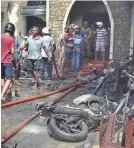  ?? M.A. PUSHPA KUMARA/EPA-EFE ?? Locals and police gather at a church in Colombo, Sri Lanka, after an explosion.