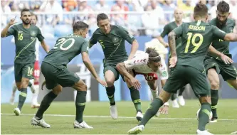  ?? — AP ?? Denmark’s Yussuf Poulsen is surrounded by Australian players during their match on Thursday.