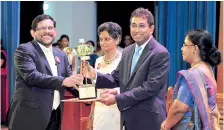  ??  ?? Omega Line Ltd Director Felix Fernando receiving the award from Dr. Harsha De Silva, Deputy Minister of Foreign Affairs at the 21st Presidenti­al Export Awards