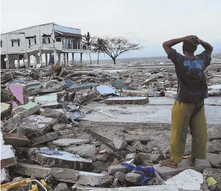  ?? AP PHOTOS ?? DISMAY: A villager yesterday stands amidst destructio­n caused by a 7.5 magnitude earthquake and tsunami in Palu, Central Sulawesi, Indonesia, on Sept. 28.