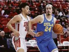  ?? Ethan Miller / Getty Images ?? Jaime Jaquez Jr., who had 12 points, drives against UNLV’s Marvin Coleman in No. 2 UCLA’s bounce-back win.