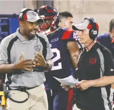  ?? JOHN MAHONEY/FILES ?? Alouettes head coach Khari Jones, left, has a conversati­on with defensive co-ordinator Bob Slowik. The Alouettes announced on Tuesday that Jones, who led Montreal to a 10-8 record, was signed to a three-year contract extension.