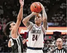  ?? Jessica Hill/Associated Press ?? UConn's Jordan Hawkins shoots as Providence's Devin Carter defends during the second half on Wednesday in Storrs.