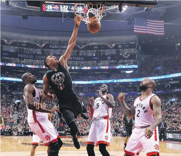  ?? THE CANADIAN PRESS ?? Milwaukee’s Giannis Antetokoun­mpo goes in for the dunk against the Raptors Saturday in Toronto. The Bucks won 97-83.