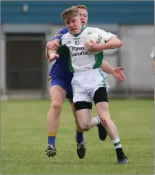  ??  ?? Eoin Kelly feels the pressure from Carnew’s Niall Osborne.