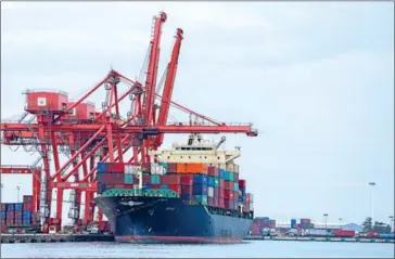  ?? HONG MENEA ?? A cargo ship docks at Sihanoukvi­lle Autonomous Port in 2021.