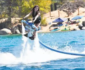  ?? NorCal Jetovator ?? A woman flies above Lake Shasta on a jetovator. The vehicles allow riders to soar up to 65 feet above the lake, busting loops and twirls.