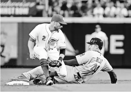  ?? DAVID KOHL, USA TODAY SPORTS ?? Advancing on a wild pitch, Cubs first baseman Anthony Rizzo slides into second base in the fifth inning vs. the Reds on Aug. 22. In the ninth, Rizzo moved over to play third base for the first time.