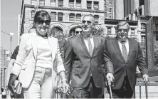  ?? Holly Pickett / New York Times ?? Amalija and Viktor Knavs, parents of first lady Melania Trump, walk with their attorney Michael Wildes, center, to the ceremony where they will become naturalize­d U.S. citizens Thursday.