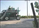  ??  ?? A large grape harvest machine drives past vineyards on Tuesday.