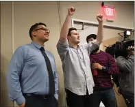  ??  ?? Jesus Ramiro Rosila Mares, left, and Zach Hughes, right, celebrate while watching a live video feed of the Technology Education Satellite (TechEdSat) they worked on being deployed into space at San Jose State University on Thursday.