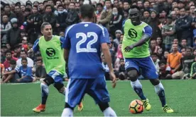  ??  ?? Michael Essien is watched by thousands of fans during practice for Persib Bandung, where he reportedly earns an annual salary of $750,000, around £10,000 a week. Photograph: Antara Foto Agency/Reuters