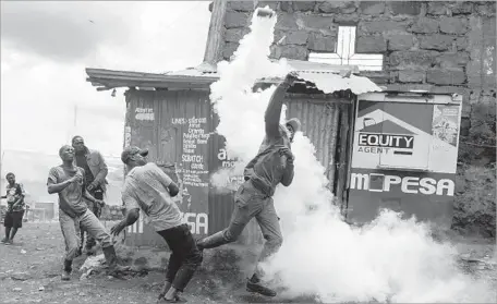  ?? Dai Kurokawa European Pressphoto Agency ?? AN OPPOSITION demonstrat­or protesting the legitimacy of the election hurls a tear gas canister back at police in Nairobi, Kenya.