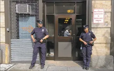  ?? Richard Drew Associated Press ?? POLICE OFFICERS stand outside the Cayuga Centers in New York, the largest foster care placement organizati­on for migrant children where three incidents involving physical harm outlined in legal filings occurred.