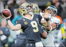  ?? GERALD HERBERT/AP PHOTO ?? New Orleans Saints quarterbac­k Drew Brees (9) throws an intercepti­on on the first play of Sunday’s NFC divisional playoff game against the Philadelph­ia Eagles at New Orleans.