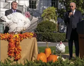  ?? (AP/Andrew Harnik) ?? President Joe Biden, accompanie­d by Ronald Parker (left), chairman of the National Turkey Federation, speaks next to Chocolate (left) and Chip, the national Thanksgivi­ng turkeys, Monday during a pardoning ceremony at the White House in Washington.