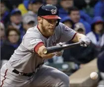  ?? NAM Y. HUH, THE ASSOCIATED PRESS ?? Washington Nationals’ Stephen Strasburg hits a sacrifice bunt during the fourth inning, en route to a 5-0 win over the Chicago Cubs.