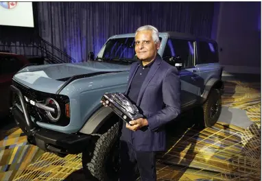  ?? (AP/Carlos Osorio) ?? Kumar Galhotra, president of Ford Blue, the company's internal-combustion business, poses next to a Bronco sport utility vehicle last month in Detroit.