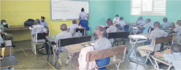  ?? Jamaica Observer (Photo: Kasey Williams) ?? In this file photo, grade six students seated in a classroom at Mile Gully Primary School last month wear masks and are evenly spaced, in keeping with COVID-19 health and safety protocols outlined by the Government, as part of a pilot for the resumption of face-to-face classes.