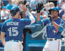  ?? FRED THORNHILL THE CANADIAN PRESS ?? Blue Jays’ Curtis Granderson, right, celebrates with Randal Grichuk after hitting a three-run home run against the Baltimore Orioles in the fourth inning in Toronto on Sunday. Granderson had six RBIs.