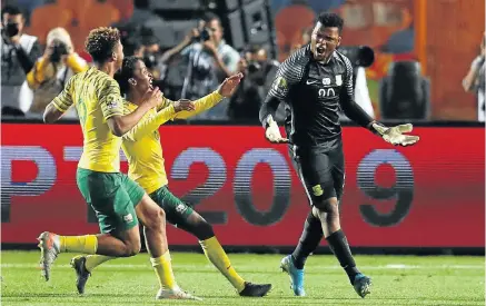  ?? Picture: Reuters ?? SA's goalkeeper Mondli Mpoto celebrates with teammates after winning a penalty shootout against Ghana at the 2019 Africa under-23 Cup of Nations in Cairo on Friday night. SA, Egypt and Ivory Coast will represent the continent in the Olympics next year.