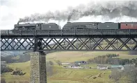  ??  ?? Steam engines go across the viaduct yesterday