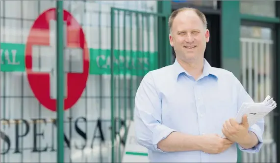  ?? GERRY KAHRMANN/PNG ?? Sensible B.C.’s Dana Larsen will canvass for a referendum that directs police away from laying simple pot-possession charges. Larsen stands outside a cannabis dispensary in the 800-block East Hastings Street on Thursday.