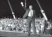  ?? JOE BURBANK/ORLANDO SENTINEL ?? President Donald Trump waves goodbye to supporters as he departs a campaign rally at Orlando Sanford Internatio­nal Airport in Sanford, Fla. on Monday.