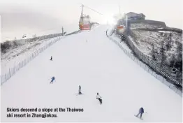  ?? ?? Skiers descend a slope at the Thaiwoo ski resort in Zhangjiako­u.