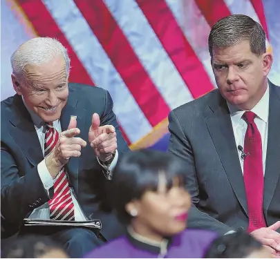  ?? STAFF PHOTO BY NANCY LANE ?? ‘HOW YA DOIN’ PAL?’ Former Vice President Joe Biden, left, gestures during the inaugurati­on of Mayor Martin J. Walsh, right, at the Cutler Majestic Theatre in Boston yesterday.