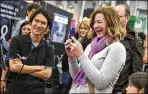  ?? NICK WAGNER / AMERICANST­ATESMAN ?? Veronica Samoulides reacts to a rap song created by Nextremer’s conversati­onal robot, known as Gochan, at the SXSW trade show on Sunday.