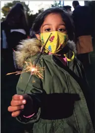  ?? ?? Jia Mundra, 4, holds a sparkler during the celebratio­n.