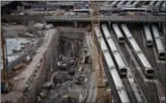  ?? THE ASSOCIATED PRESS ?? In this April 2014 photo, backhoes excavate in a hole reserved for a rail tunnel, left, during the early days of constructi­on at the Hudson Yards redevelopm­ent site on Manhattan’s west side in New York. A concrete box was planned inside the project to...