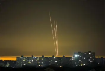  ?? Vadim Belikov/Associated Press ?? Four Russian rockets launched against Ukraine from Russia’s Belgorod region are seen Thursday at dawn in Kharkiv, Ukraine.