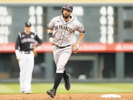  ?? Matthew Stockman / Getty Images ?? Brandon Belt circles the bases after hitting a grand slam in the first game of a doublehead­er at Coors Field.