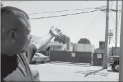  ?? RAY CHAVEZ — STAFF PHOTOGRAPH­ER ?? Francisco Parga, who works as a mechanic across the street, shows the warehouse where immigrant workers were allegedly forced to work on projects without pay.