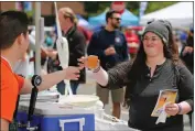  ?? JOSEPH GEHA — STAFF ARCHIVES ?? Kaylene Ogden, right, of Hayward, picks up a cherry hefeweizen tasting at the Burger and Brew Fest in Fremont in 2018.