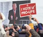  ?? OLIVIER DOULIERY/AFP VIA GETTY IMAGES ?? People listen to former President Donald Trump at the annual March for Life in Washington, D.C., in January.