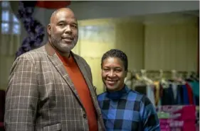  ?? Alexandra Wimley/Post-Gazette ?? Pastor Jerome Hurst and his wife, Carolyn, of Ethnan Temple Seventh-day Adventist Church, stand in front of packages being prepared for Toys for Tots recipients in the church basement.