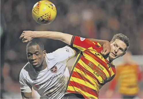  ??  ?? 0 Hearts striker Uche Ikpeazu, left, challenges for the ball against Partick Thistle defender Steven Saunders during last night’s 1-1 draw.