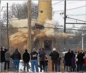  ??  ?? Explosions start the downfall of the two smokestack­s from the former Sonoco paper mill plant.