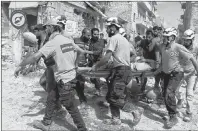  ?? SYRIAN CIVIL DEFENSE WHITE HELMETS VIA AP, FILE ?? In this Wednesday, Sept. 21, 2016, file photo, provided by the Syrian Civil Defense White Helmets, rescue workers move a victim from the site of airstrikes in the al-Sakhour neighborho­od of the rebel-held part of eastern Aleppo, Syria.