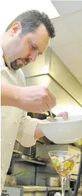  ??  ?? Chef Christophe Ithurritze of Sage restaurant uses lemons to cure scallops in ceviche.