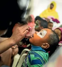  ??  ?? Three-year-old Haarun Ahmed, of Newtown, experiment­s with a new look at the Wellington Islamic Centre’s cultural day.